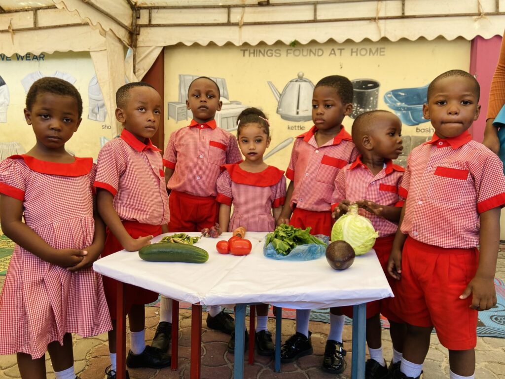 A proud line-up behind the fresh vegetables display.