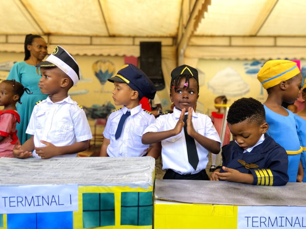 Young pilots and cabin crew staff their cardboard airport terminals.