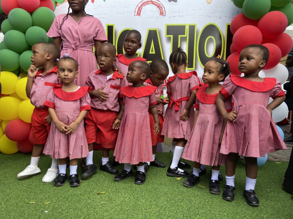 Our littlest learners line up at the education-themed balloon arch.