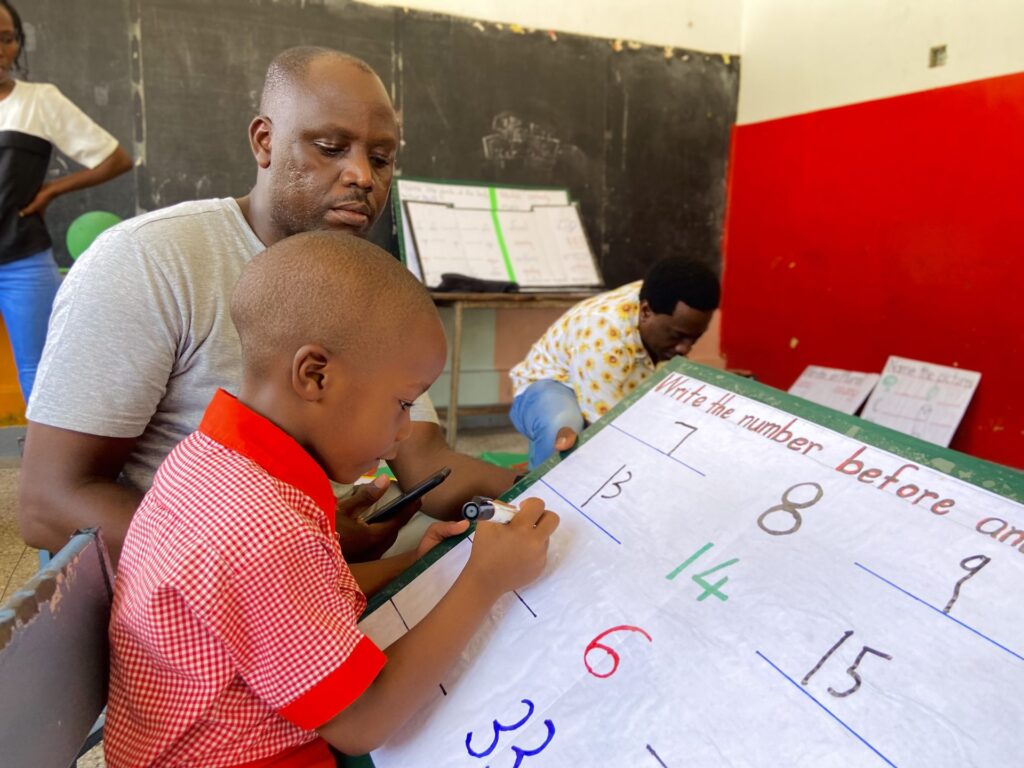 Heads together over number work in the classroom.