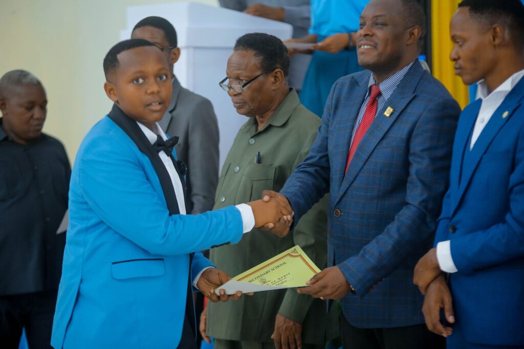 A proud handshake on stage