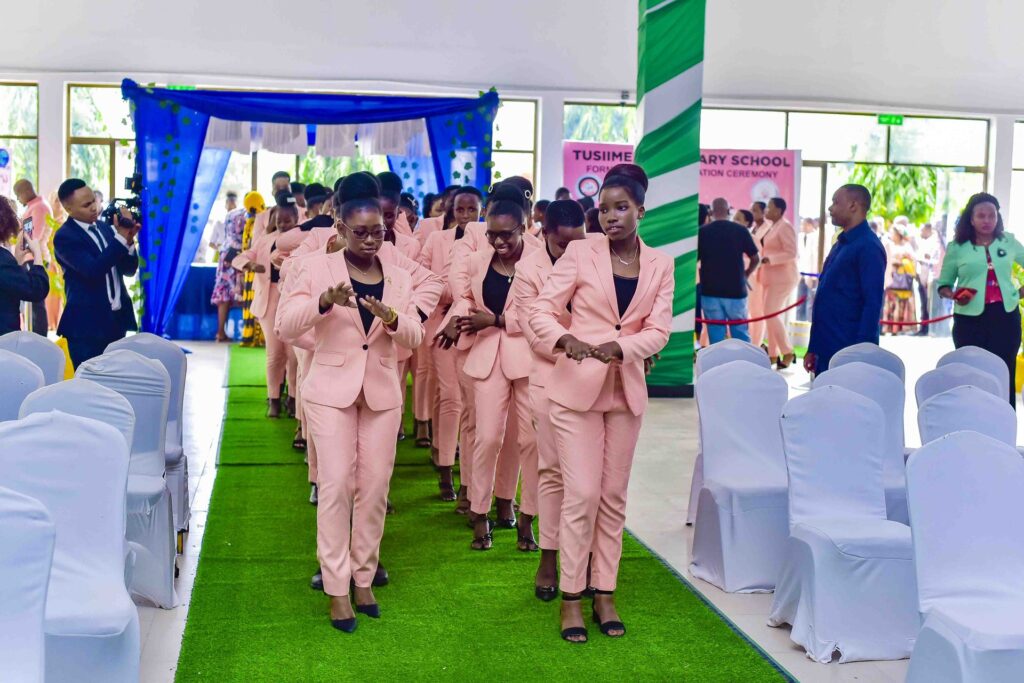 The Form Four class dances its way down the aisle