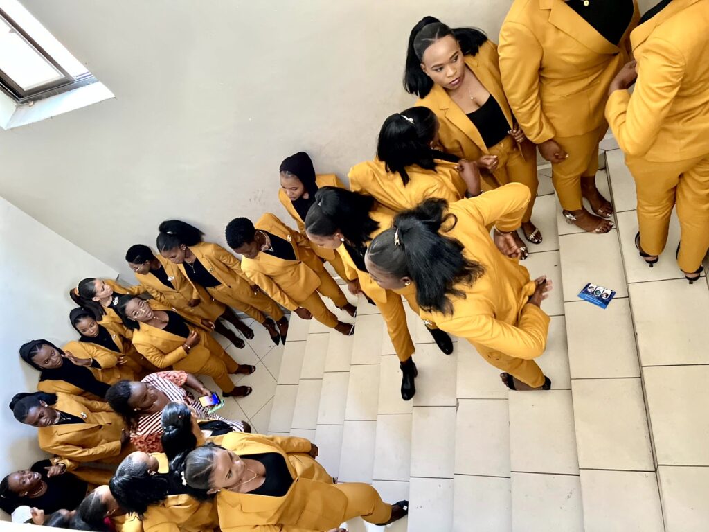 Graduates wind down the staircase on their way to the hall