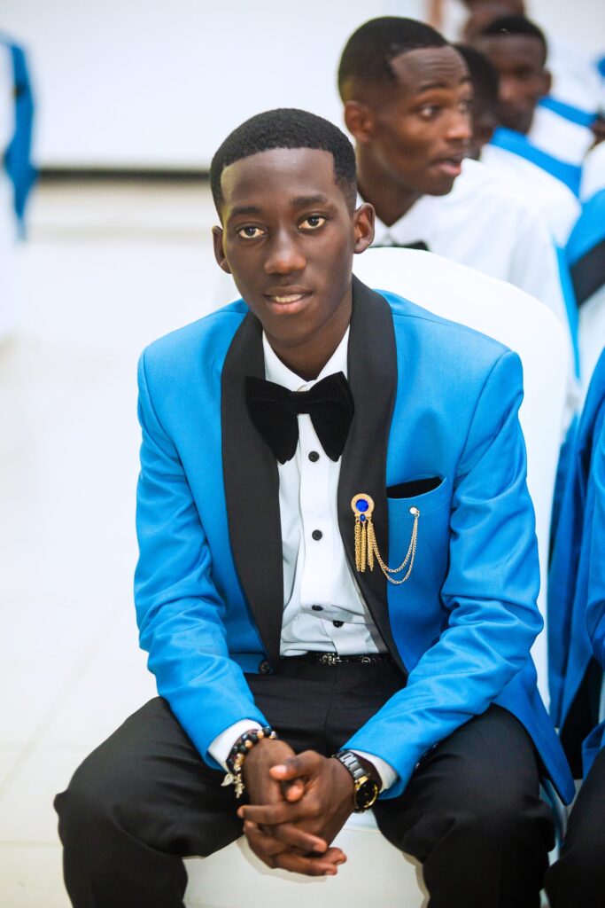 Sharp in blue and black, a graduate enjoys the ceremony.