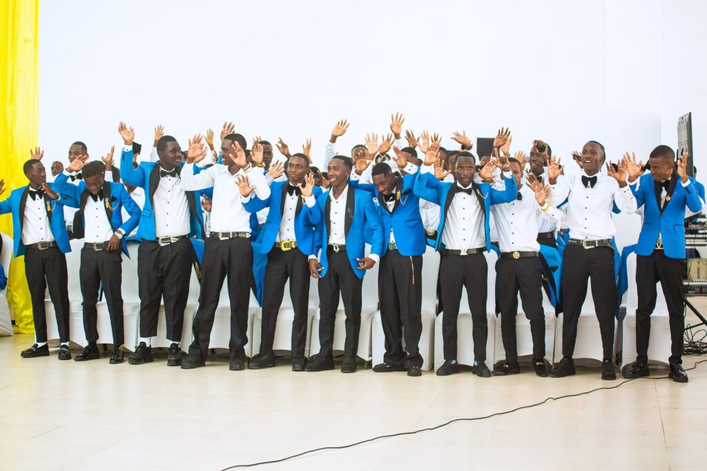 Hands in the air — the boys celebrate in song.