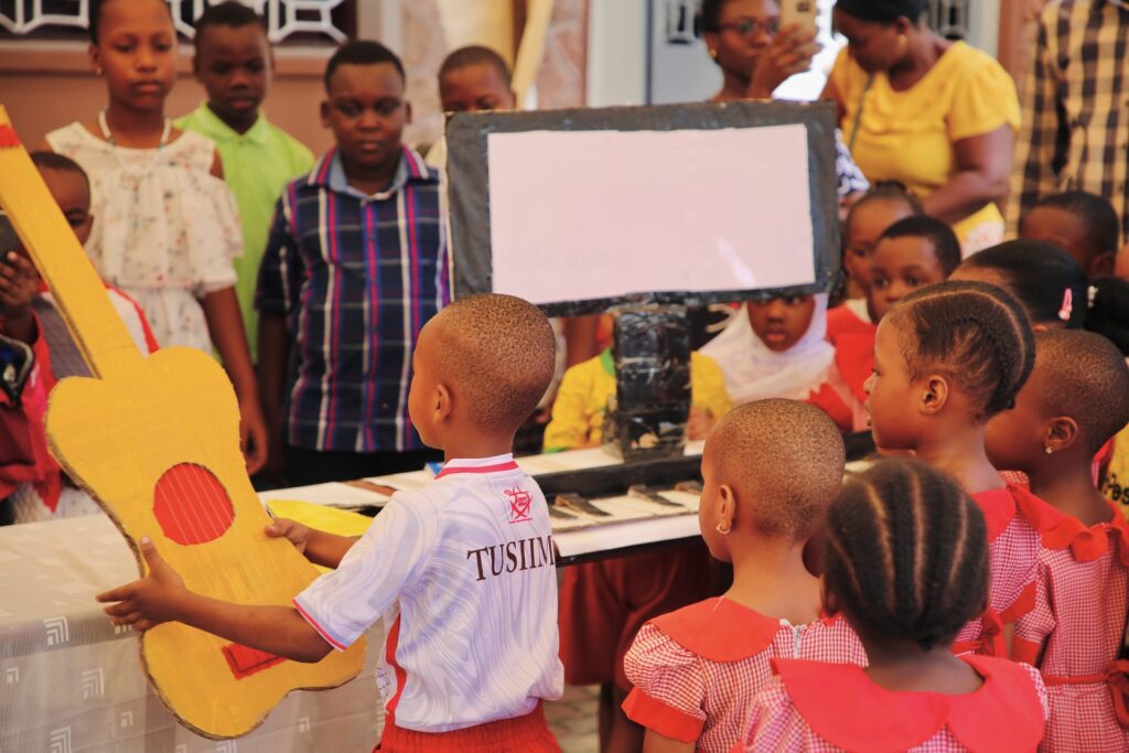 Trying the cardboard guitar at the music display