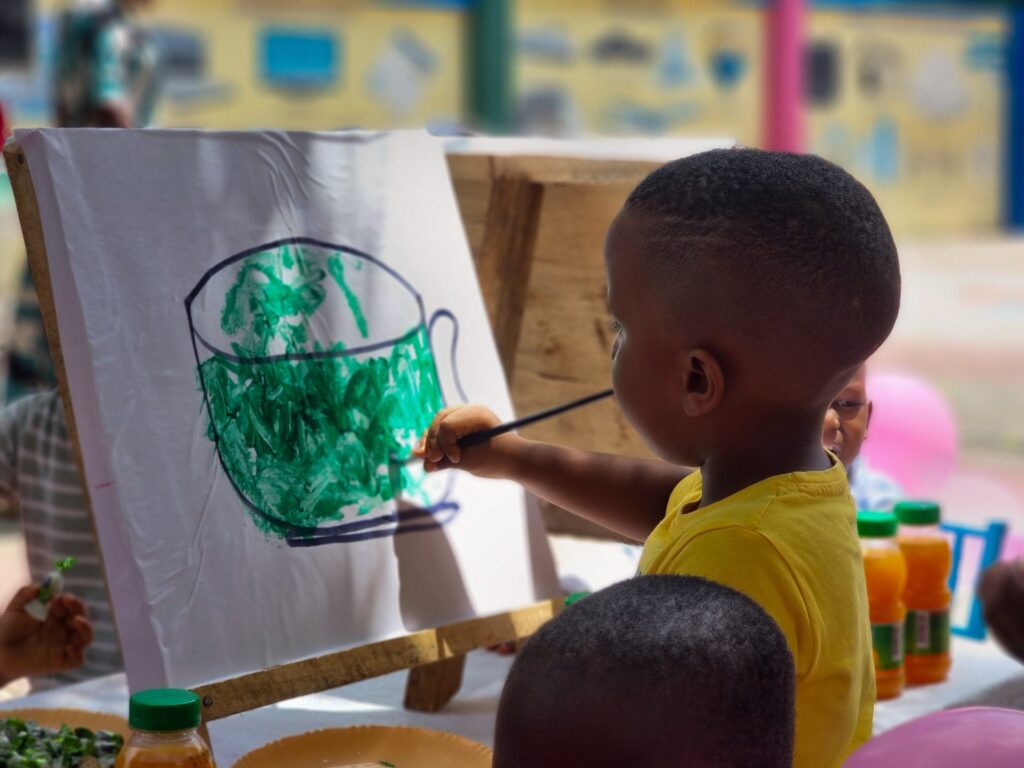 Carefully painting a green cup