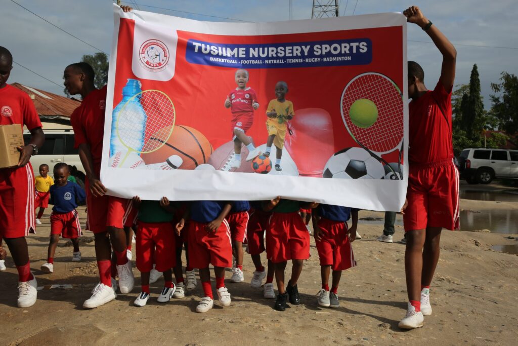 Pupils carry the sports day banner on the morning march