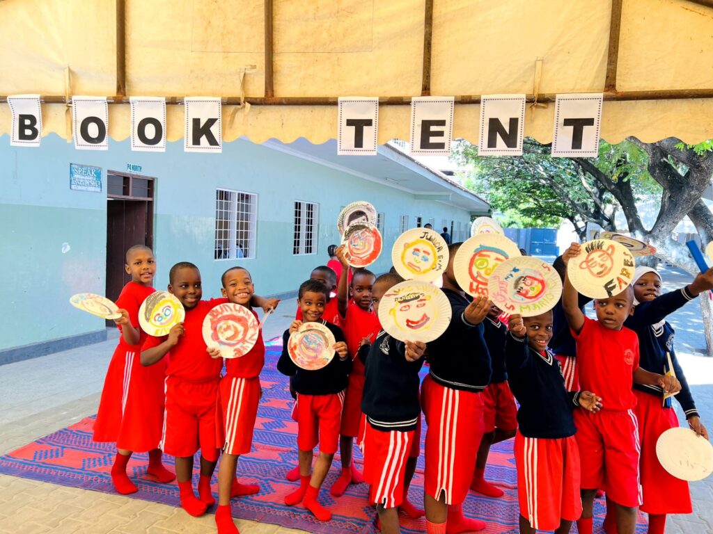 Paper-plate book characters on parade.