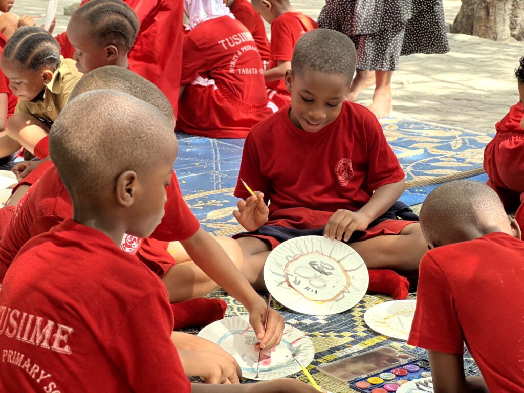 Painting story characters onto paper plates.