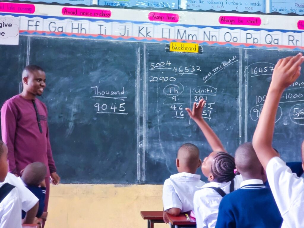 A hand goes up during the morning numeracy lesson.