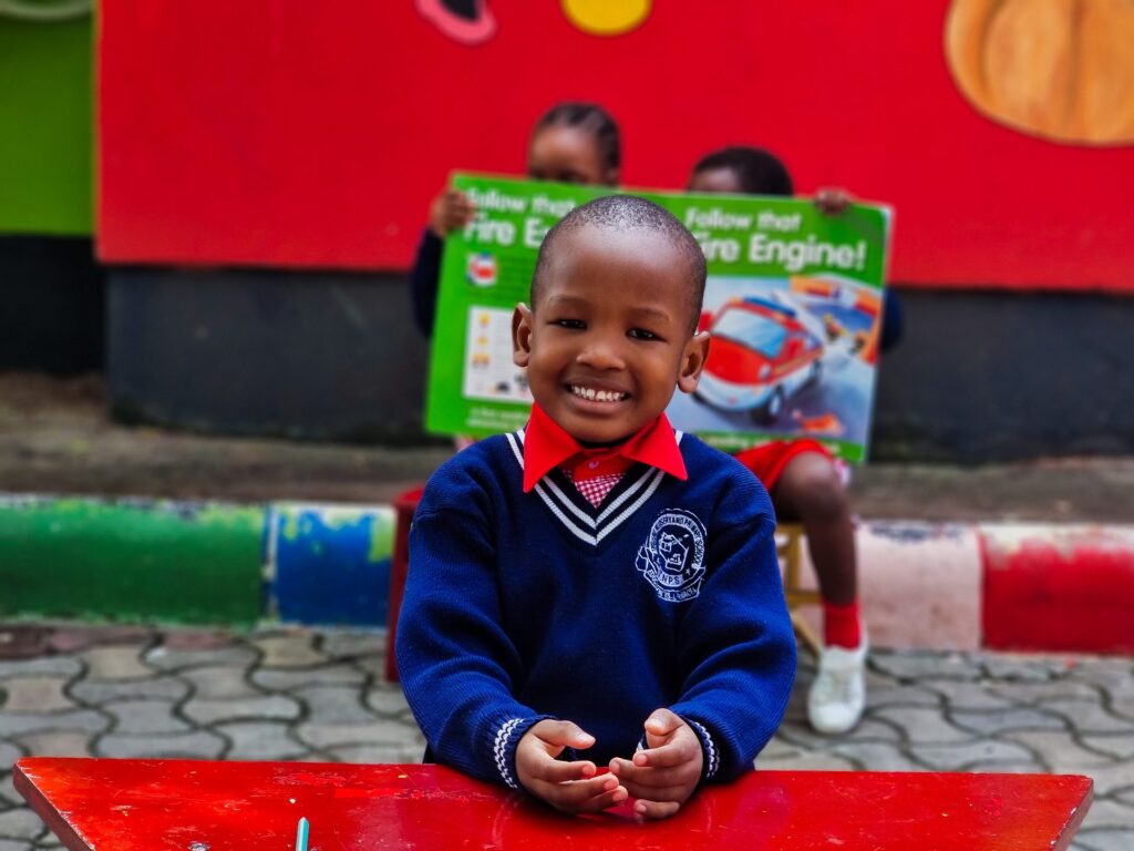All smiles at storybook time outdoors.