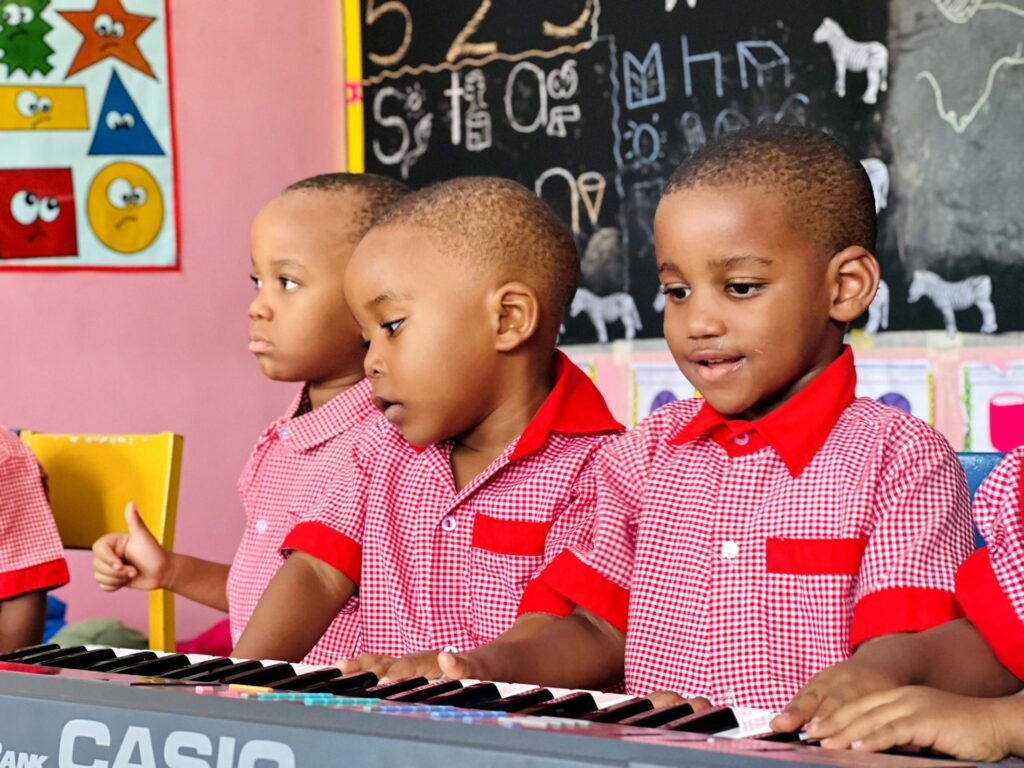 Singing along at the keyboard in music class.
