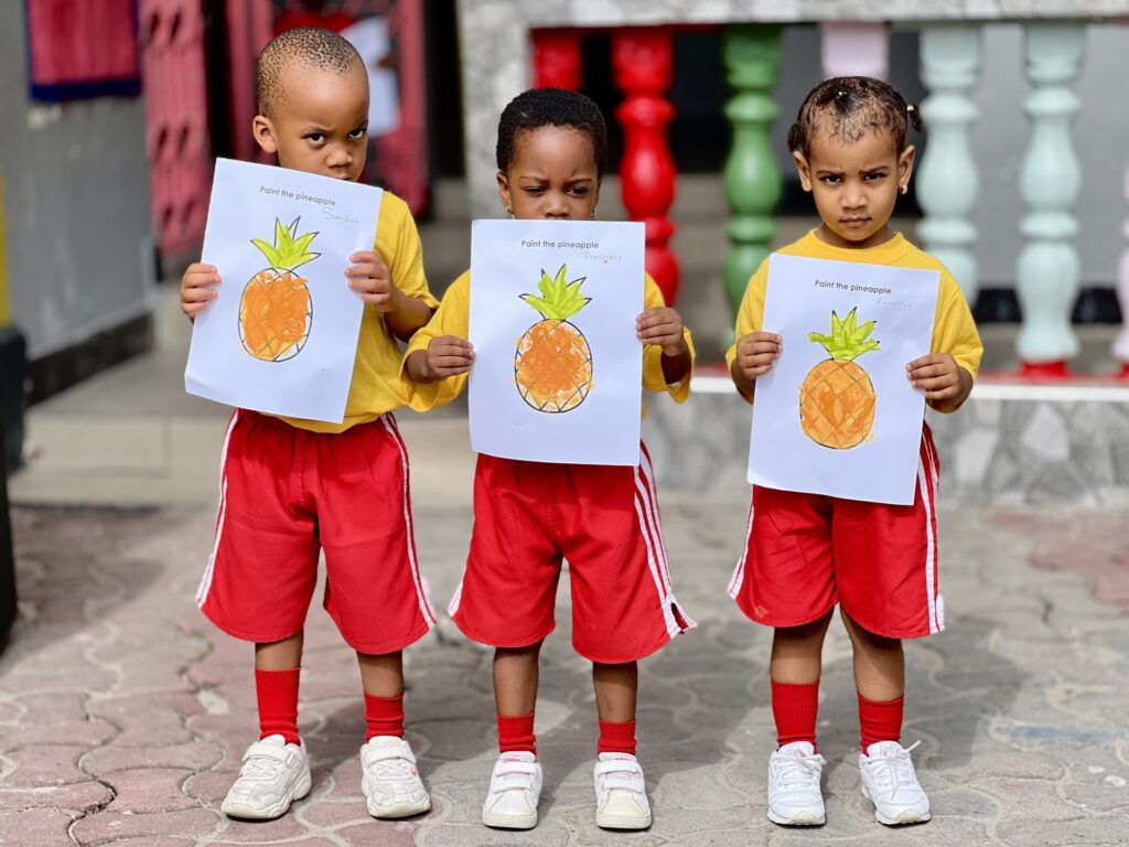 Proud painters show off their pineapples.