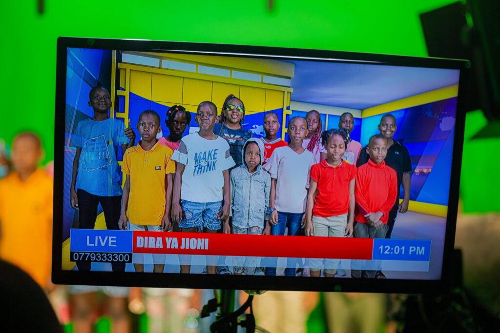 On screen! The scouts appear on the studio monitor.